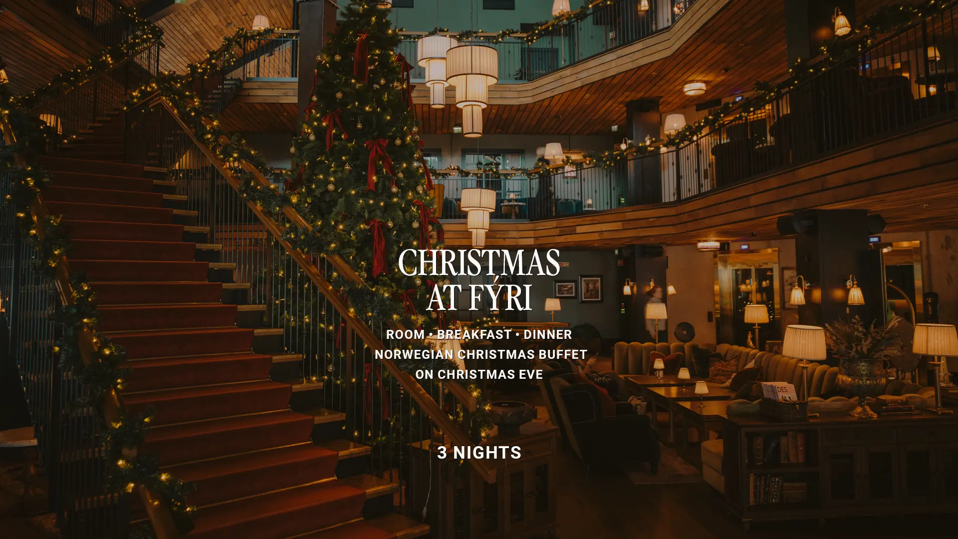 Hotel lobby decorated for Christmas, with a large Christmas tree, string lights and a staircase with a red carpet. Text overlay: “Christmas at Fýri – Room, Breakfast, Dinner, Norwegian Christmas buffet on Christmas Eve, 3 nights”.